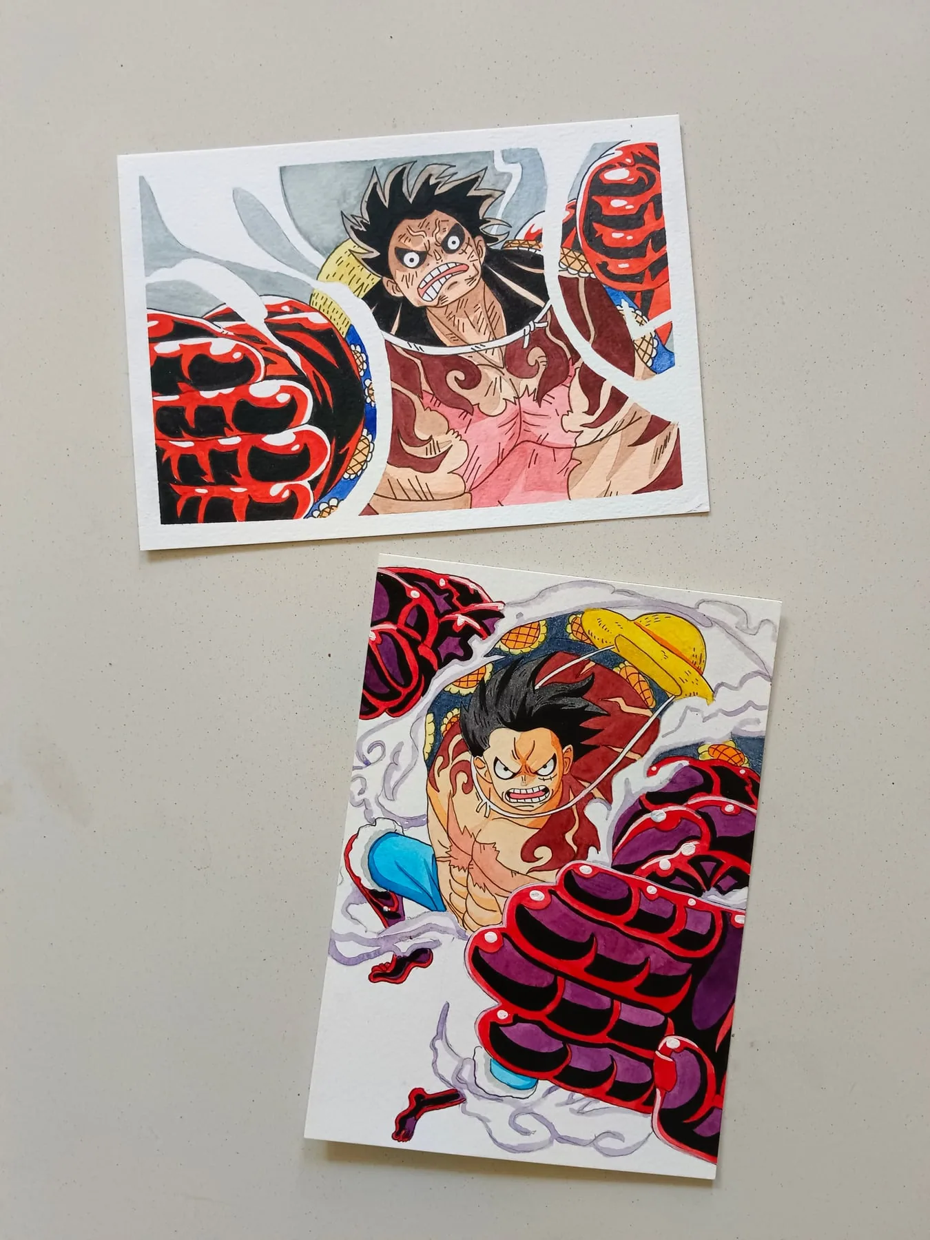 Pair of hand-painted acrylic One Piece action paintings featuring Monkey D. Luffy with red energy effects.