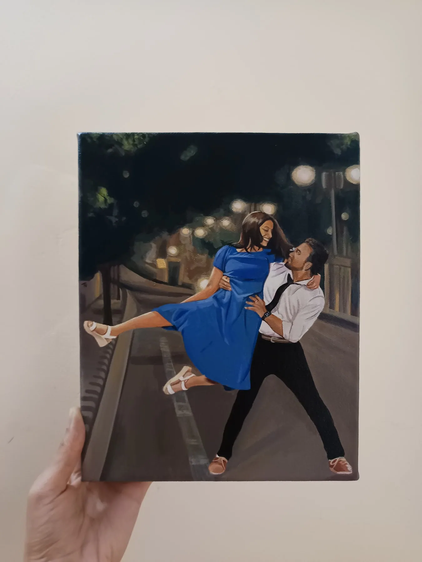 Hand-painted acrylic canvas portrait of a couple dancing at night.