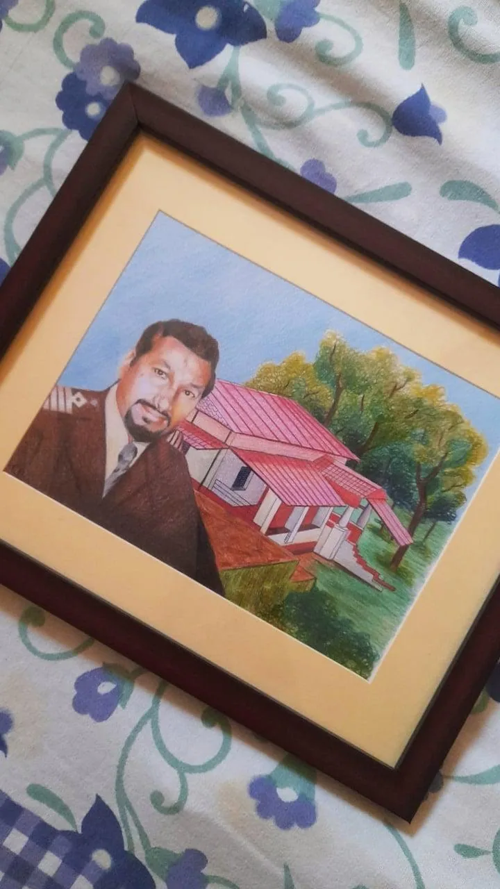 Framed colour-pencil portrait of a couple with a scenic house and garden background.
