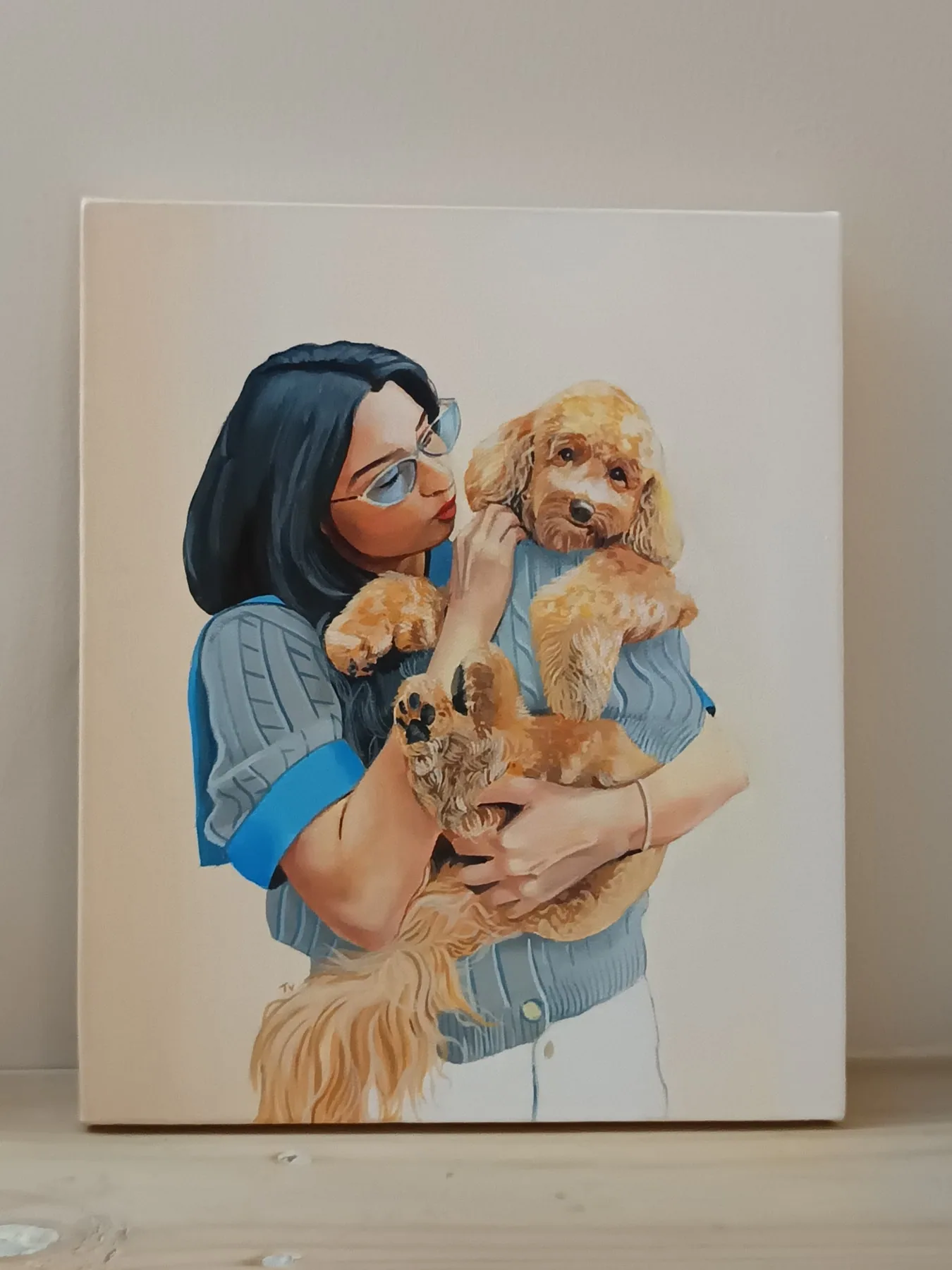 Hand-painted acrylic canvas portrait of a person holding a golden dog on a light background.