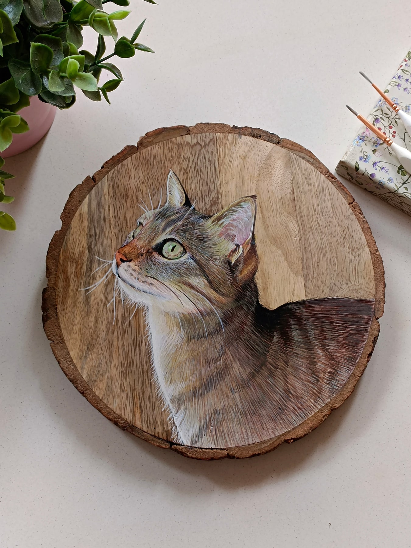 Cat portrait painted on a round wood slice