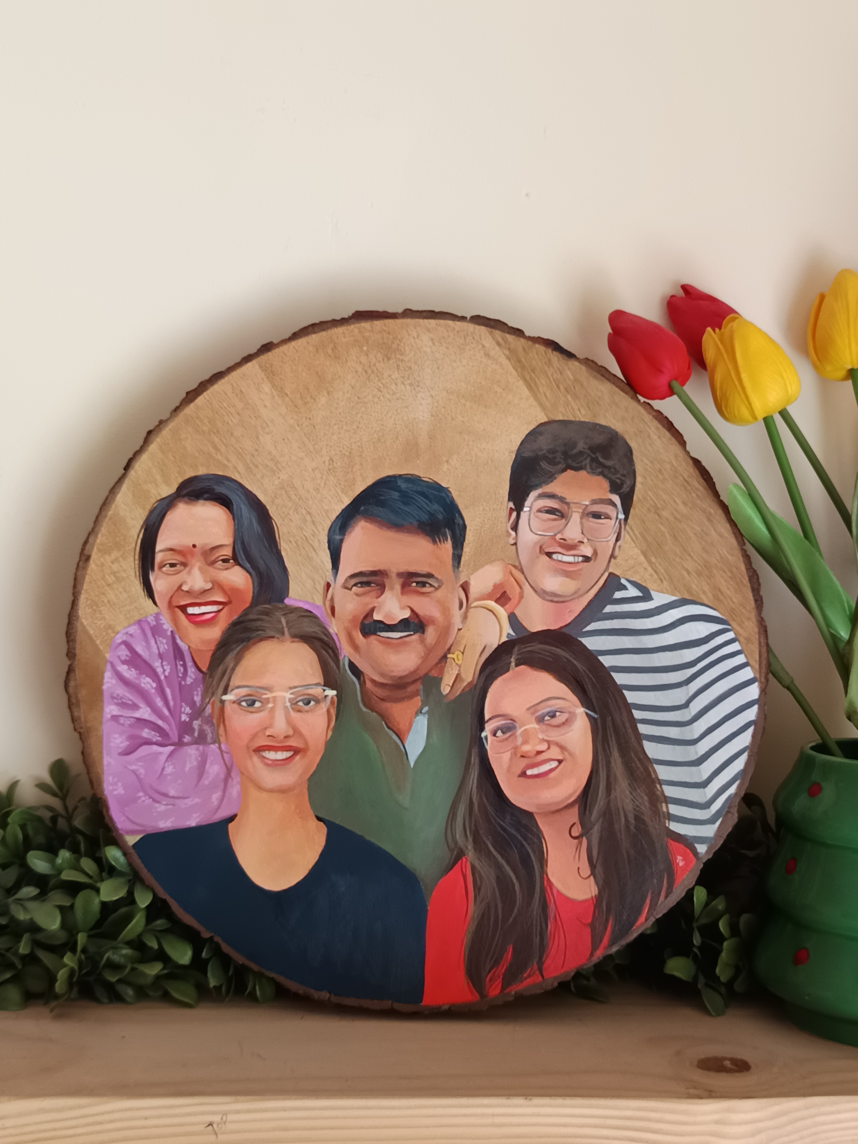 Hand-painted portrait of a family of five on a round natural wood slice with visible bark edges.