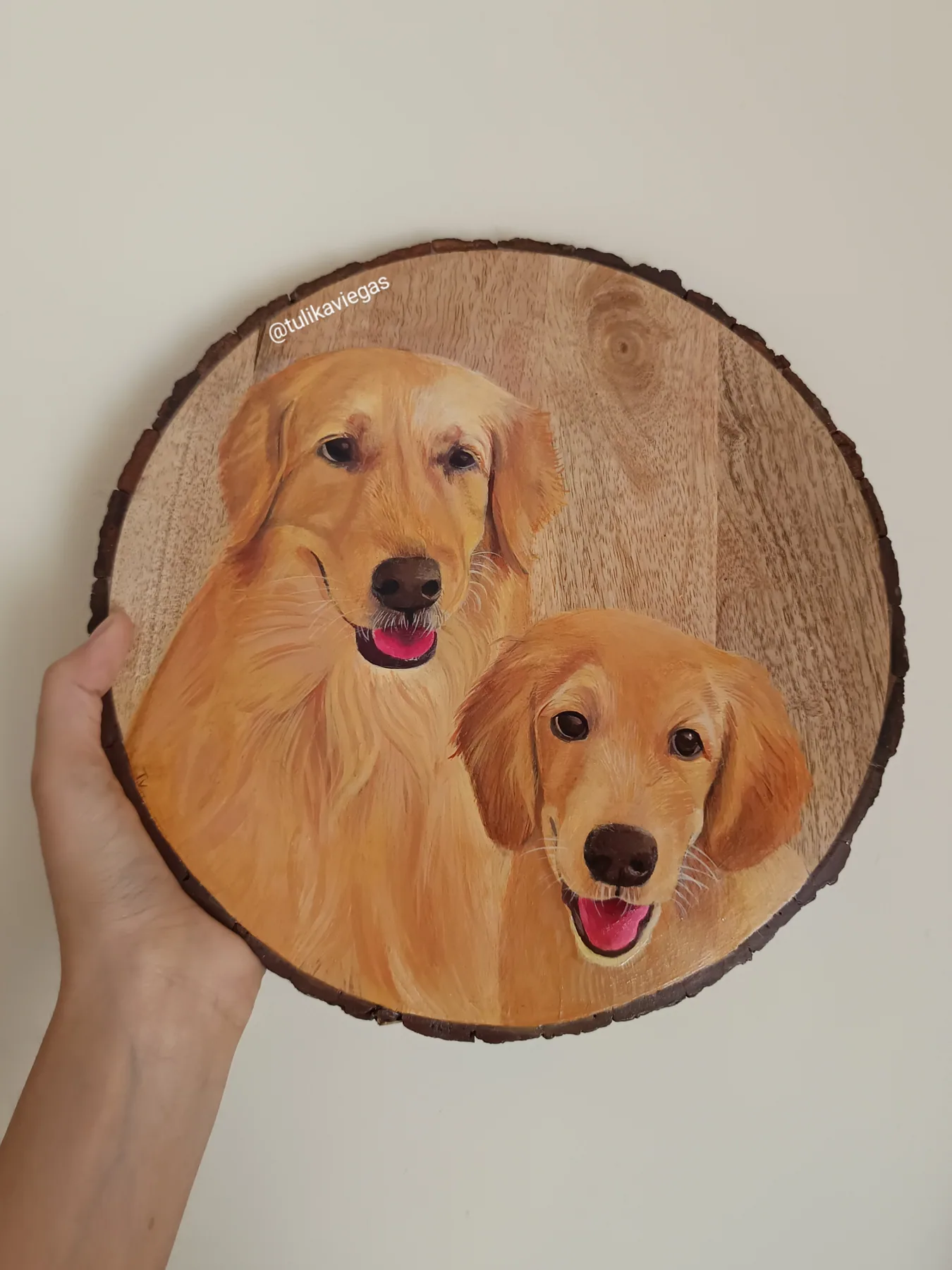 Round wood slice painting of two golden-coloured dogs, made as a friendly custom pet portrait keepsake.